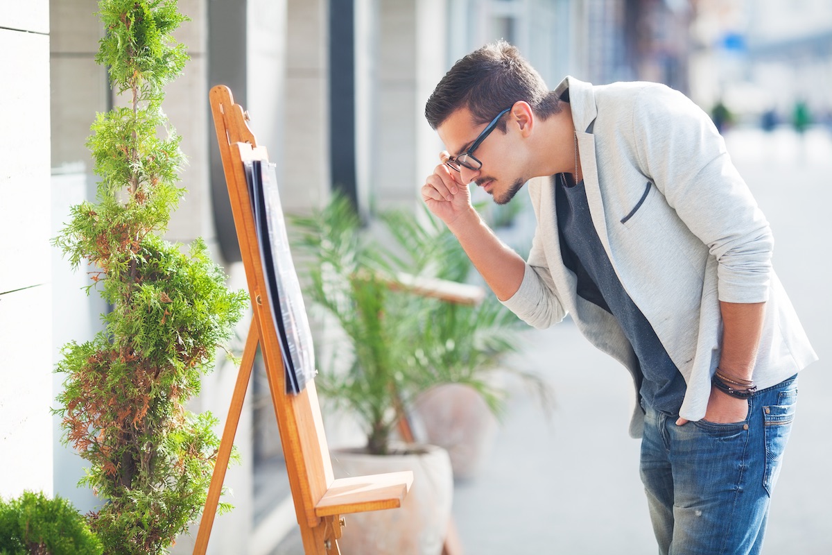 Pedestrian checking out the menu outside